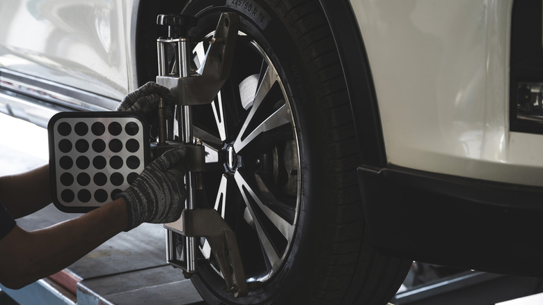 Car wheel getting aligned at a service shop