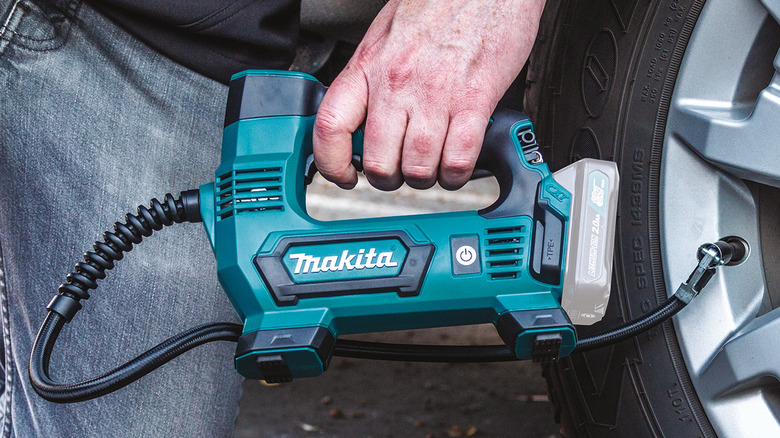 Makita CXT inflator being used to inflate a tire.
