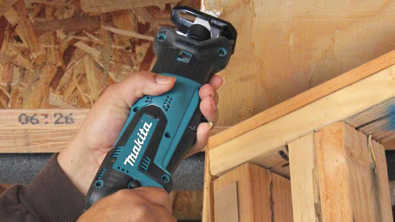 DIYer using a Makita reciprocating saw