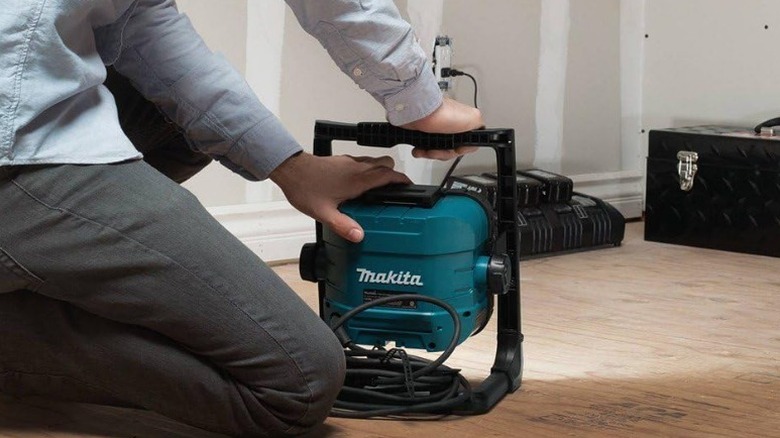 Person angling Makita DML805 18V LXT Cordless/Corded LED Flood Light