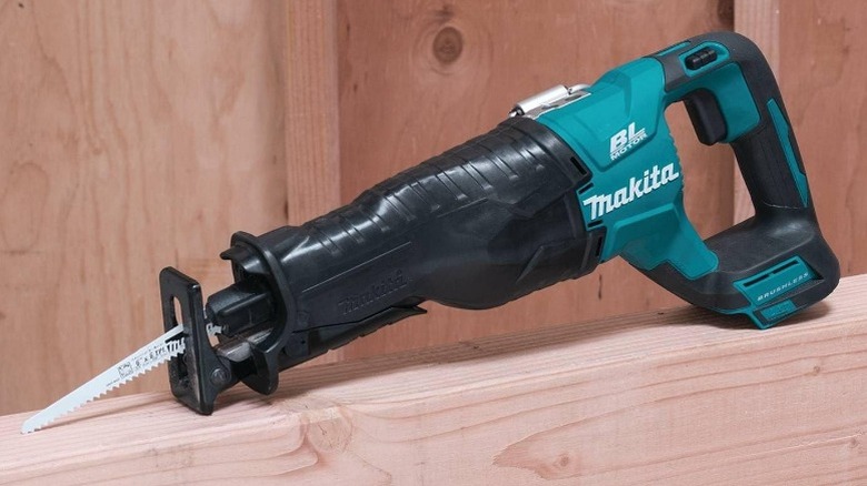 Makita XRJ05Z 18V Cordless Brushless Reciprocating Saw resting on wall stud