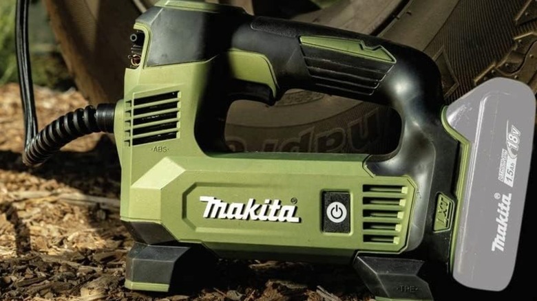 Makita inflator next to a wheel