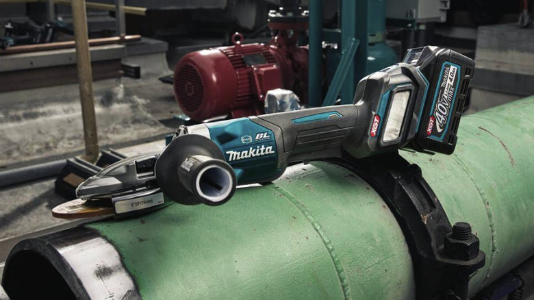 Makita flathead grinder resting on job site