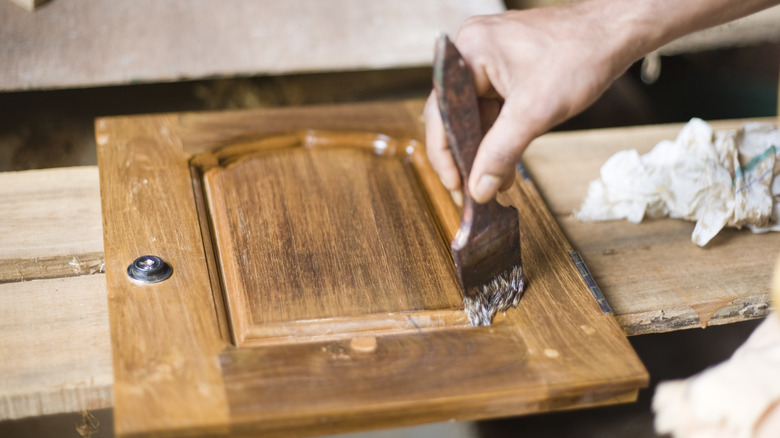 person finishing cabinet door