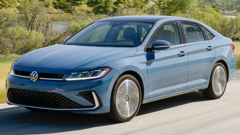 2025 Volkswagen Jetta In Blue Driving Along A Scenic Road