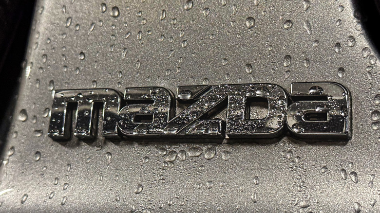 Mazda logo with water droplets