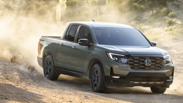 Front 3/4 view of green Honda Ridgeline TrailSport on desert trail.