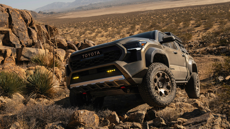 Front view of Toyota Tacoma Trailhunter rock crawling on desert trail.