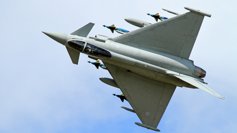 Eurofighter Typhoon fighter jet seen banking hard to the left carrying multiple missiles