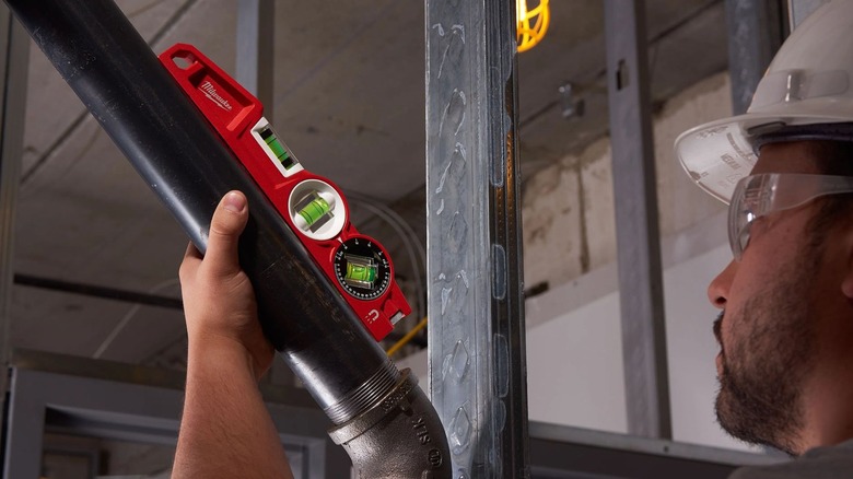 Man using Milwaukee 10-Inch Torpedo Level