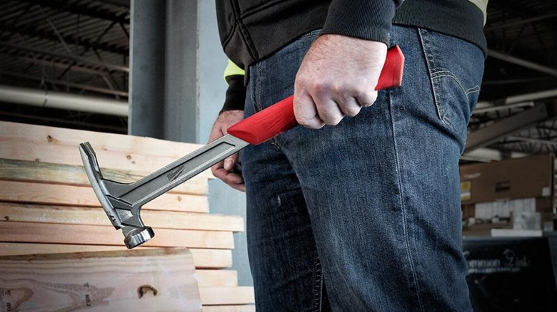 Man holding Milwaukee Smooth Face Framing Hammer