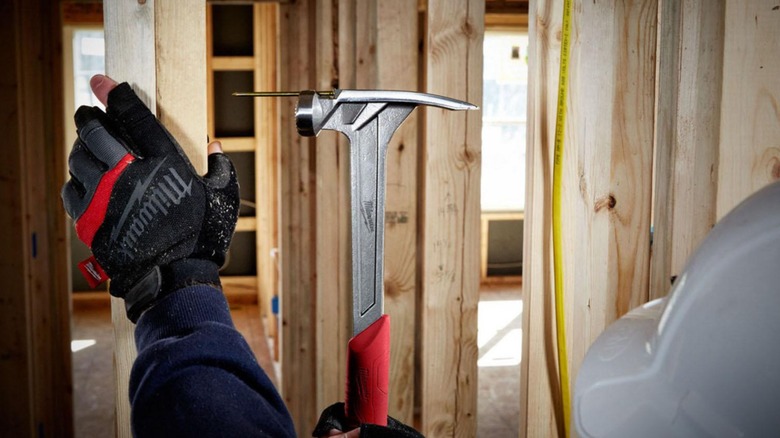 Man using Milwaukee Smooth Face Framing Hammer