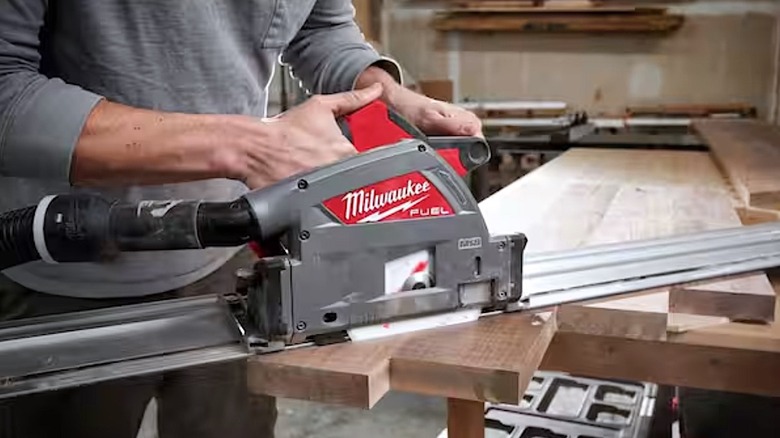 Person using Milwaukee M18 track saw