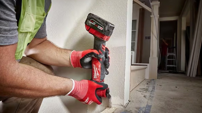 Person holding Milwaukee oscillating multi-tool