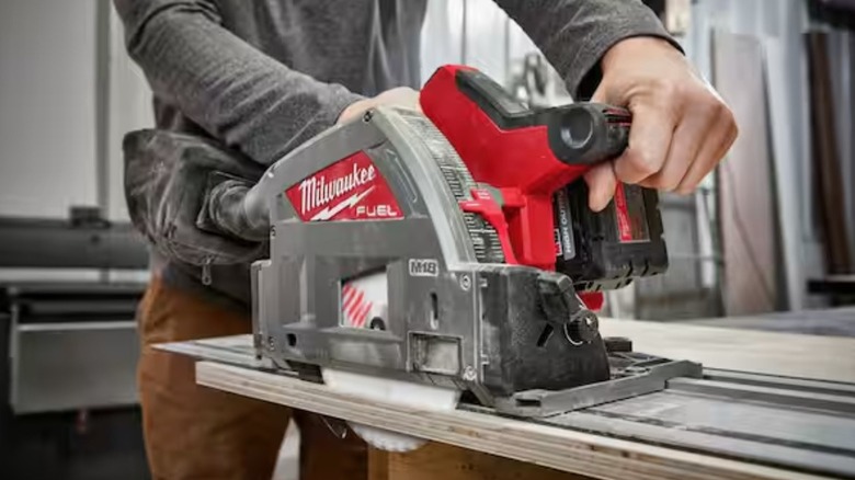 Person using Milwaukee M18 track saw