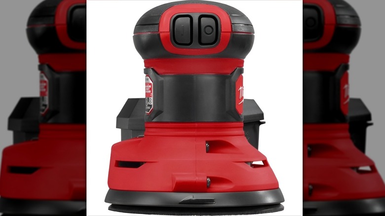 Milwaukee orbit palm sander on white background
