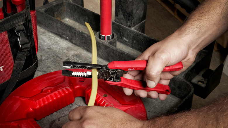 man using Milwaukee Combination Pliers on wire