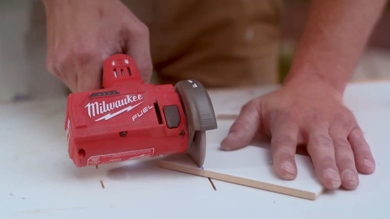 Milwaukee M12 FUEL 3-inch Compact Cut Off Tool used on a tile