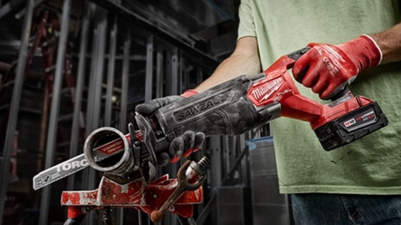 Person using Milwaukee M18 Fuel Sawzall Reciprocating Saw on pipe