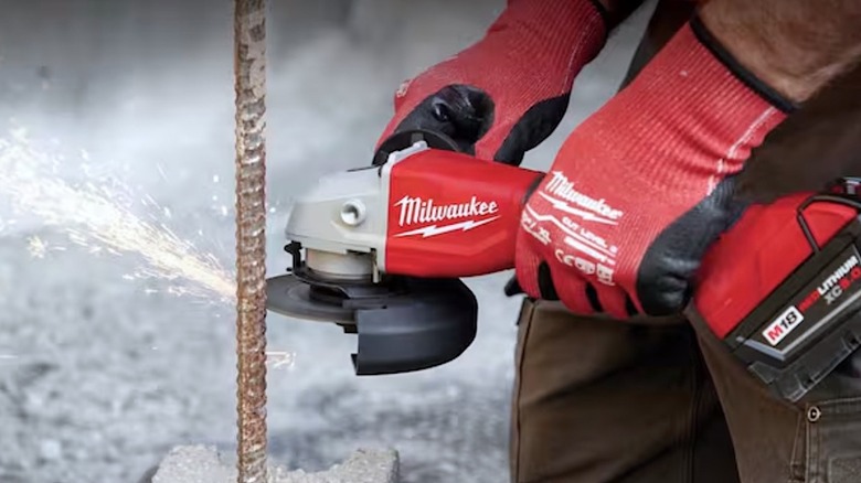 Person using Milwaukee tool to cut steel rod