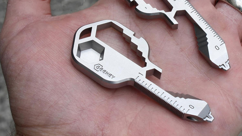 A Geekey key in the palm of someone's hand.
