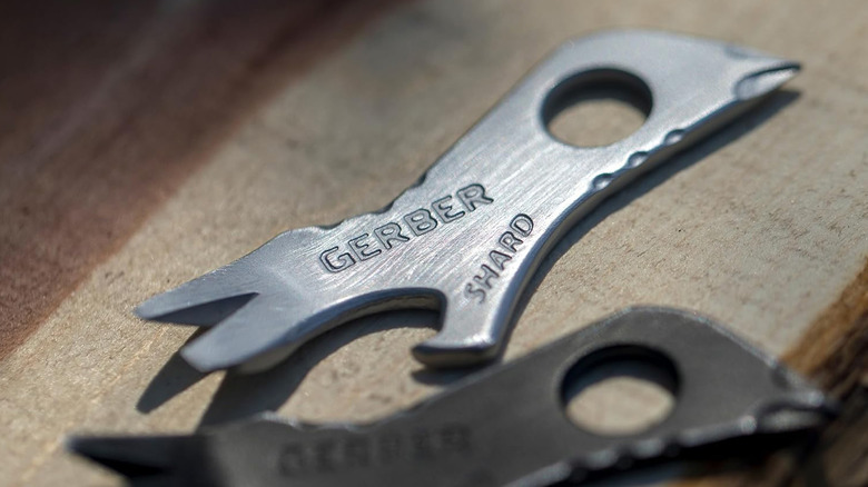 A Gerber Shard tool on a wood table next to another Gerber Shard