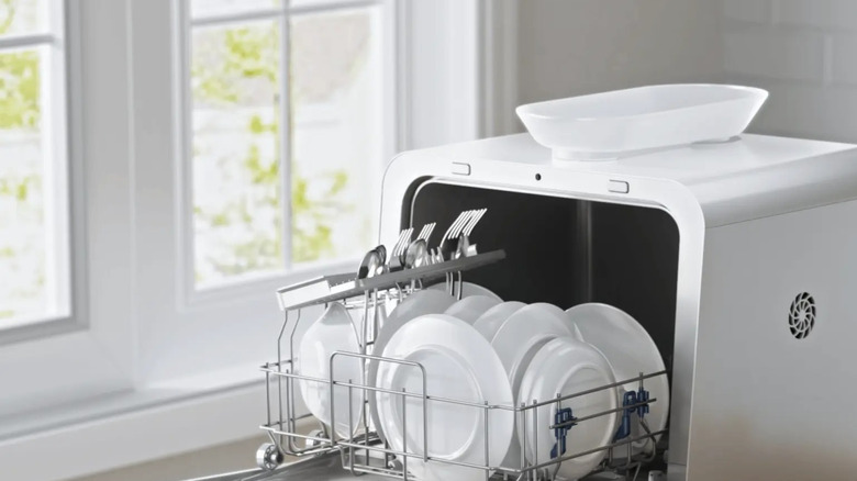 Midea Portable Countertop Dishwasher on kitchen counter with dinnerware inside