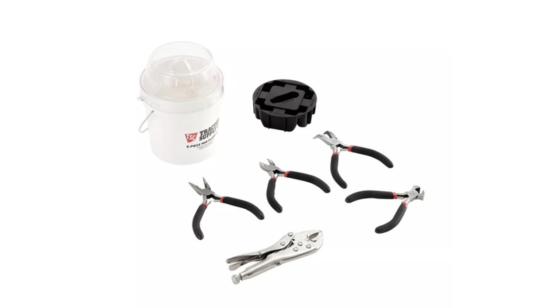 A set of miniature pliers with storage bucket against white background
