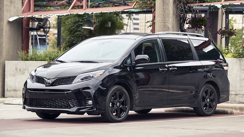 Front 3/4 view of black 2020 Toyota Sienna parked in parking lot.