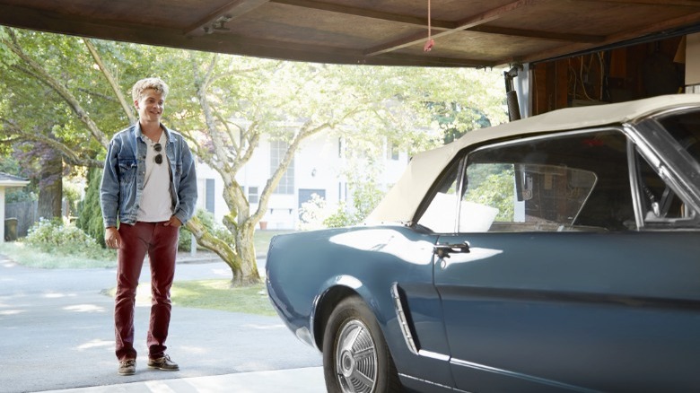 person looking at a classic car 