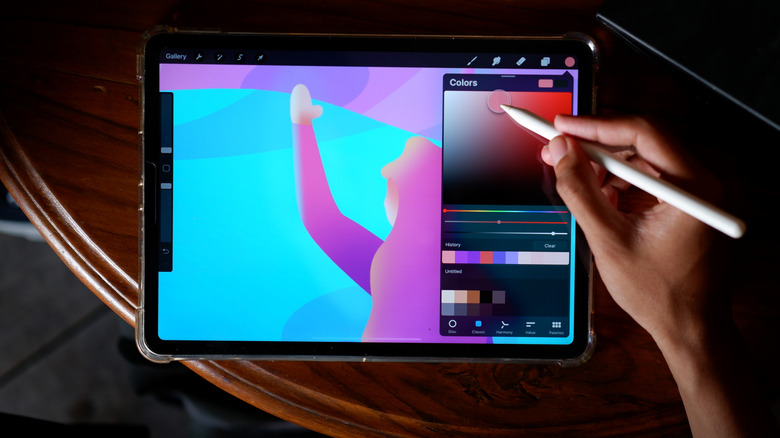 A person using the Procreate app on their iPad.