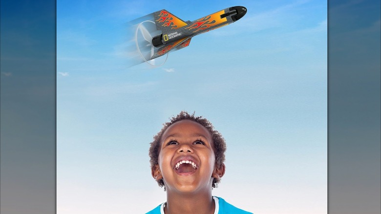 A child looking at motorized rocket