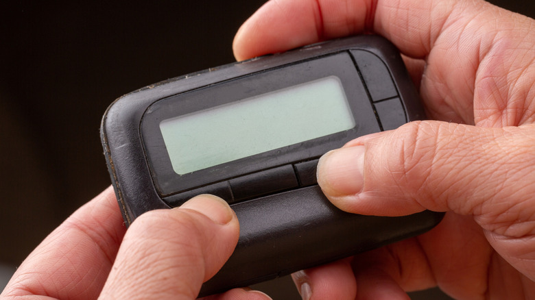 Hands holding pager