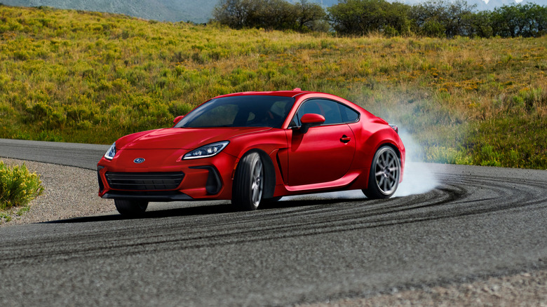 A 2027 Subaru BRZ with tires spinning around a corner