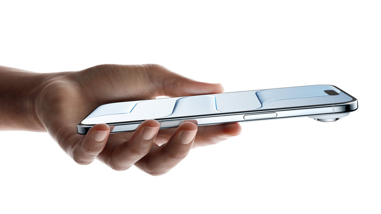 A hand holding the iPhone Air over a white background.