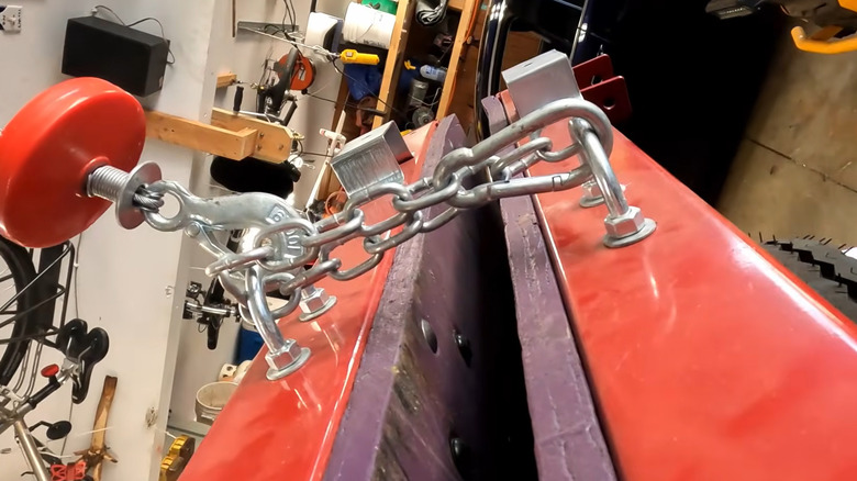 U-bolts and a chain on a folded Harbor Freight trailer