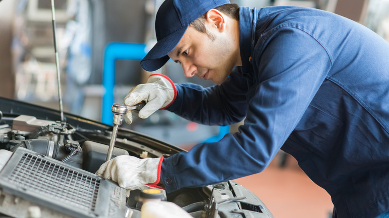Auto mechanic working on a car
