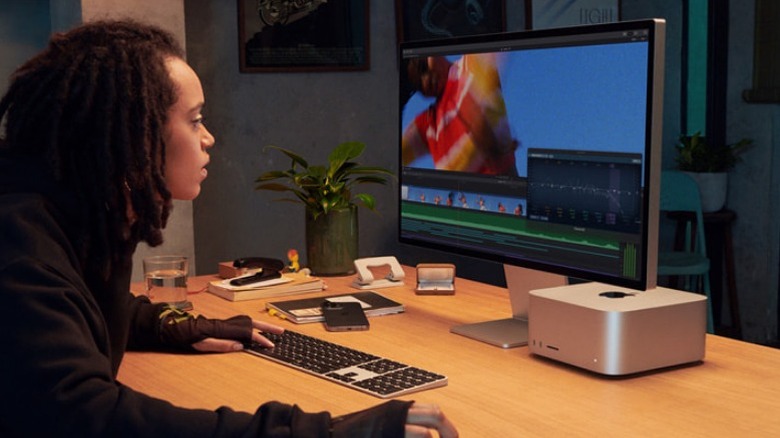 Woman using Apple Studio Display