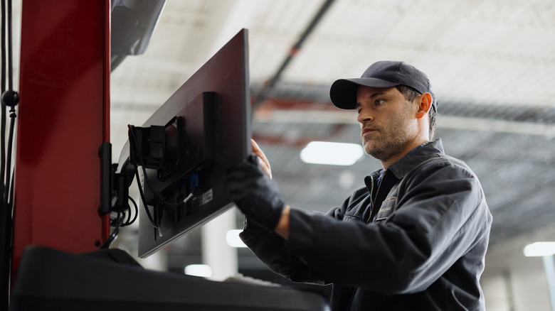 Man examining monitor