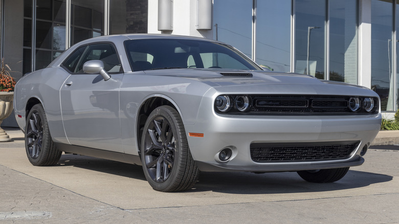 A silver base model Dodge Challenger SXT parked outside.