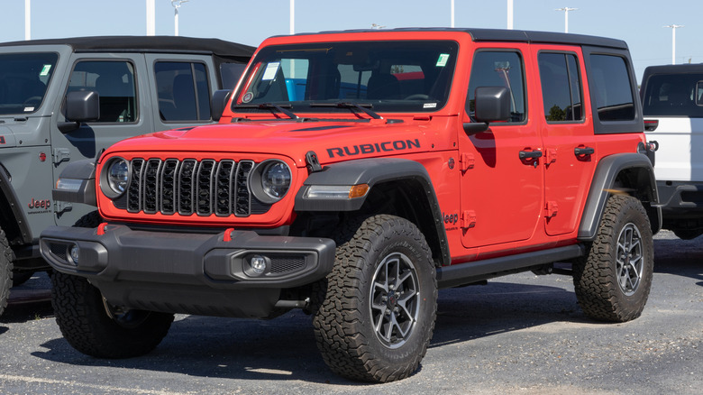 A Rubicon red Jeep Wrangler parked in a Jeep Wrangler parking lot.