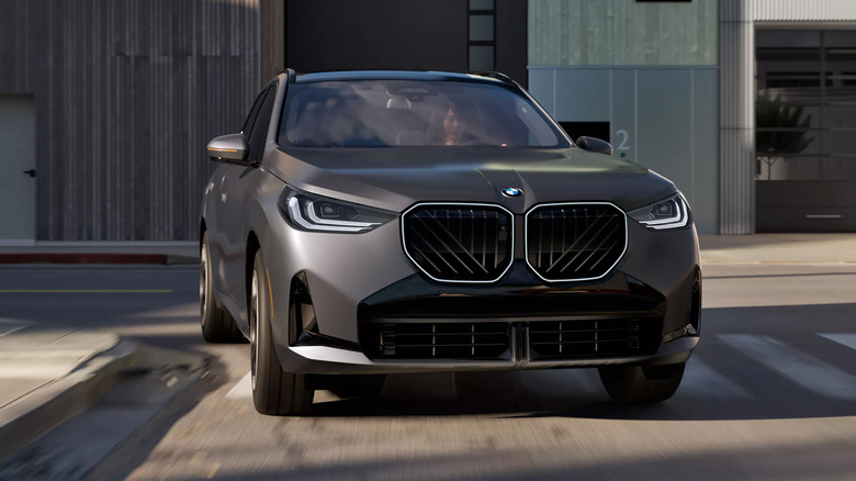 A gray 2026 BMW X3 driving