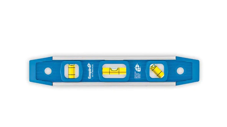 person holding a torpedo level