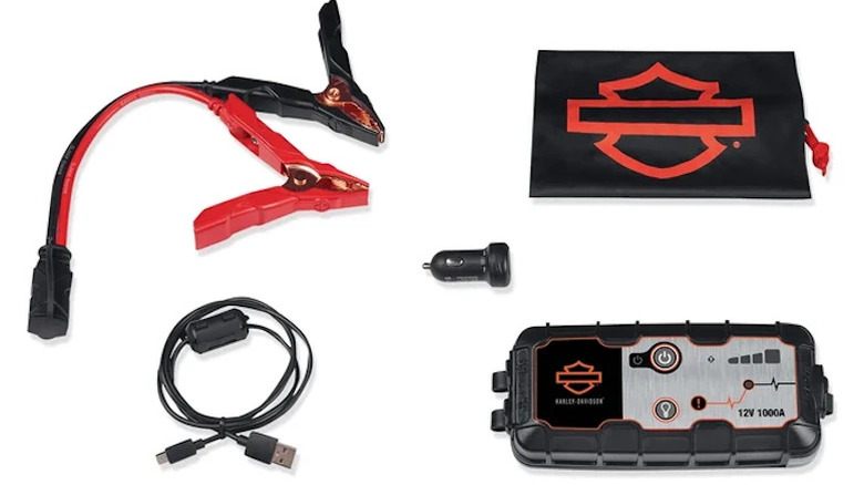 Jumper cables, USB cords, and battery pack surrounded by a white background