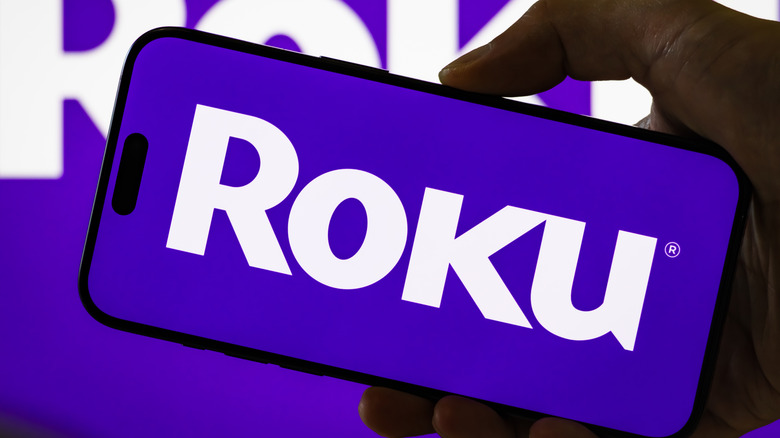 The Roku logo on a smartphone