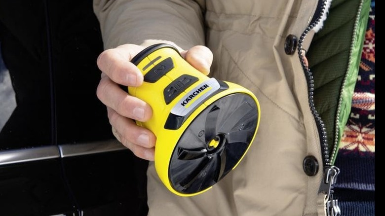 person holding windshield cleaner