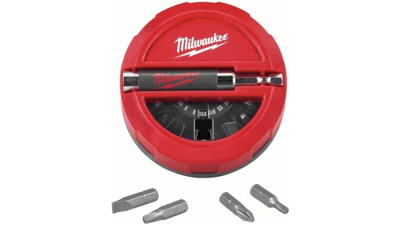 A circular red case for screwdriver bits, some are outside the case
