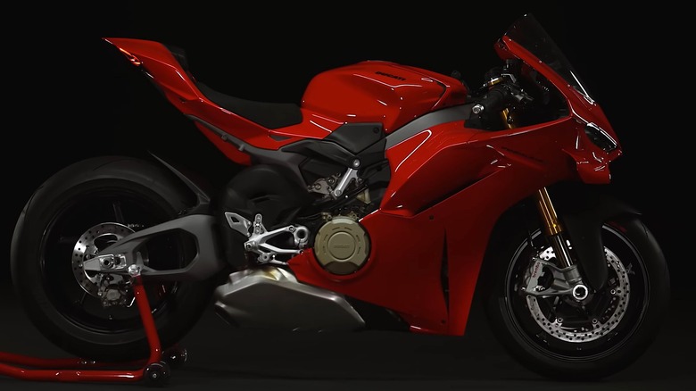 A 2025 Ducati Panigale V4 in red, a muscular Italian power cruiser that blends superbike performance with bold street-fighter styling.