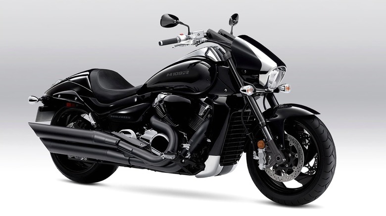 A 2024 sleek black Suzuki Boulevard M109R cruiser motorcycle displayed in a studio setting with a clean gray background.