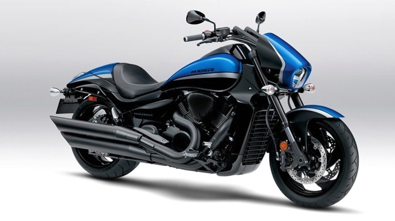 A striking 2024 blue Suzuki Boulevard M109R shown in profile, highlighting its bold curves and dual exhaust system.